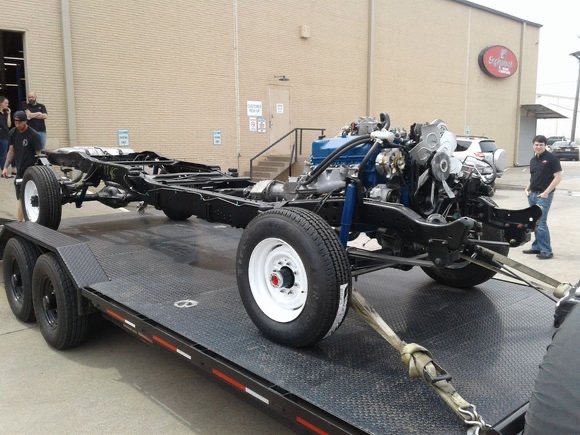 Complete chassis with engine, transmission, and drivetrain on trailer