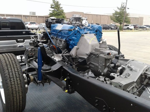 Blue Ford 400 V8 engine mounted on restored frame