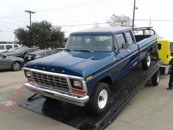 Front three-quarter view of the restored truck on delivery trailer